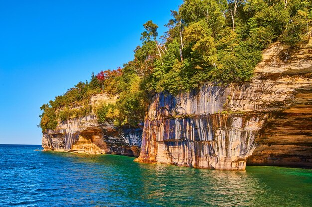 Turquoise green waters with soaring cliffs of pictured rocks national park