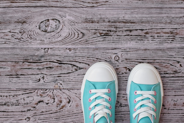 Turquoise shoes on hardwood floor