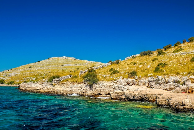 Turquoise water paradise lagoon in archipelago islands of the kornati archipelago national park in croatia landscape view from the sea boat