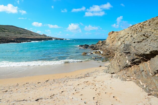 Turquoise water sand and rocks in Argentiera beach Sardinia