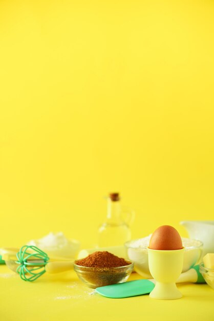 Turquoise and yellow cooking utensils on bright background Food ingredients Macro of eggs Cooking cakes and baking bread concept Copy space