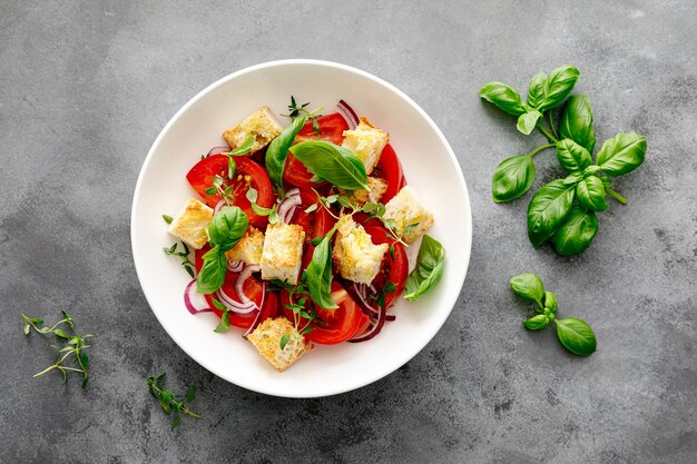Tuscan Panzanella salad with tomatoes basil and bread top view
