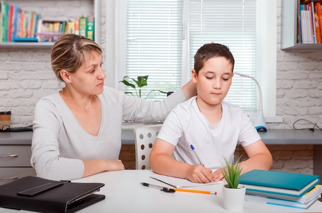 The tutor is engaged with the child, teaches to write and count