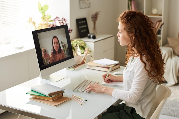 Photo tutor talking to university student