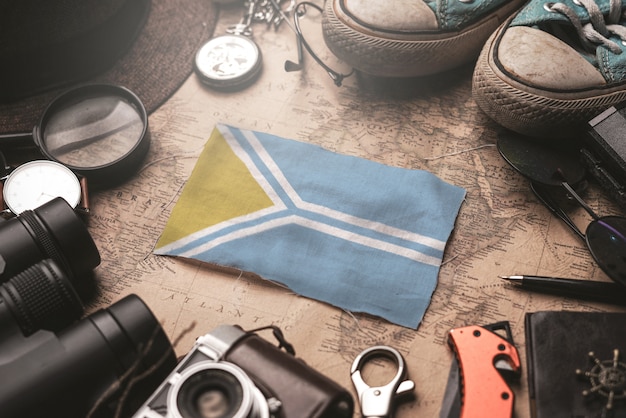 Tuva Flag Between Traveler's Accessories on Old Vintage Map. Tourist Destination Concept.