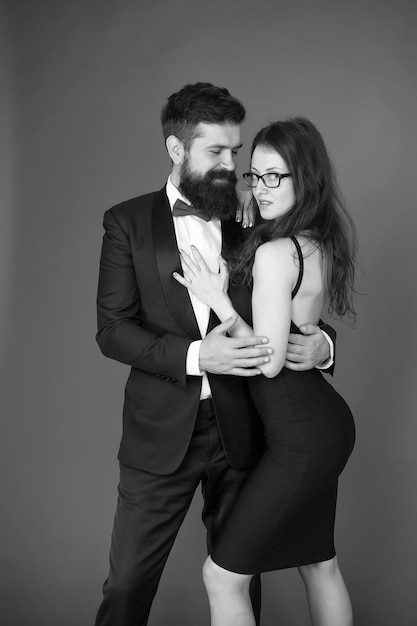 Tuxedo and dress formal couple art experts of bearded man and\
woman esthete romantic relationship couple in love on date formal\
party tuxedo and dress for formal event pleased with each\
other