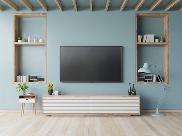 Premium Photo | Tv on the cabinet in modern living room on blue wall  background,3d rendering