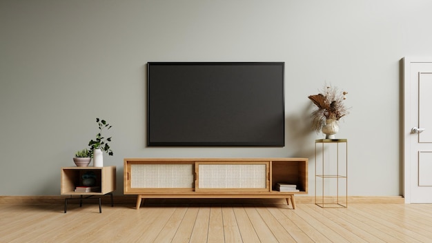 회색 벽 배경의 현대적인 거실에 있는 캐비닛의 TV