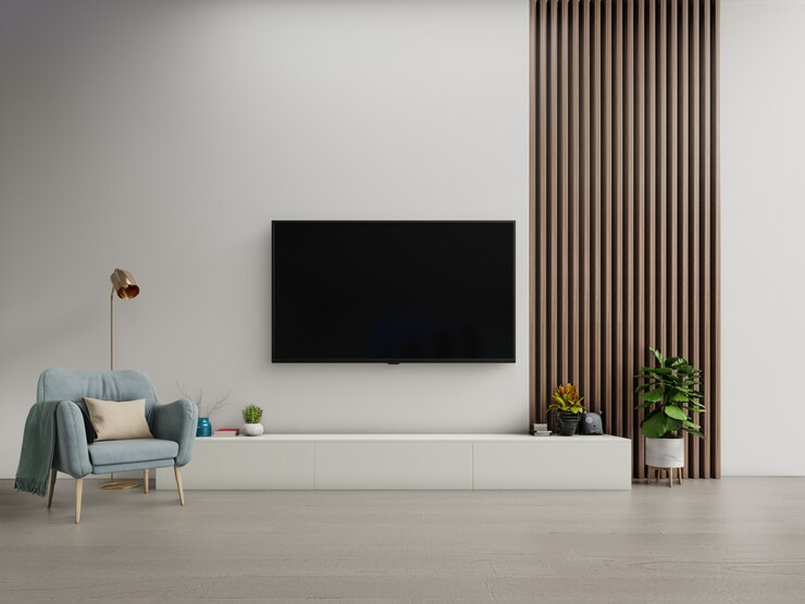 Photo tv on the cabinet in modern living room with armchair on white dark wall.