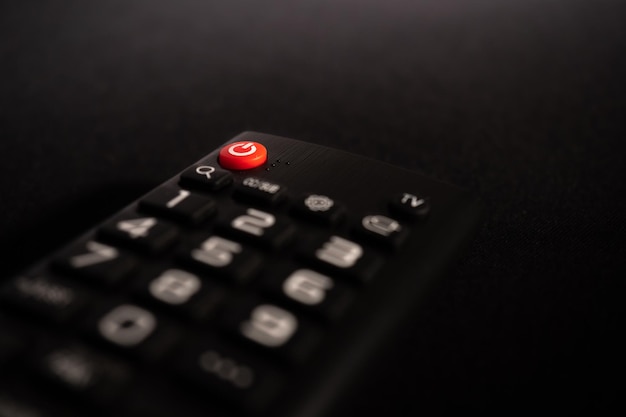 Photo tv power button on the remote control on black background