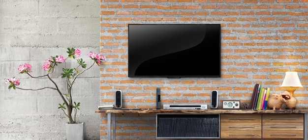 Tv on red brick wall with wooden table in living room