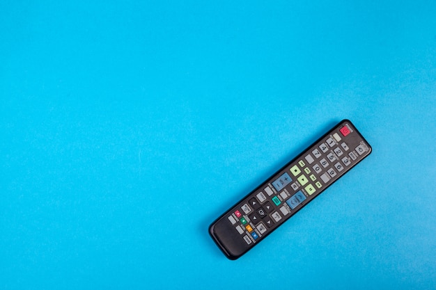 Tv set remote control on blue  top view