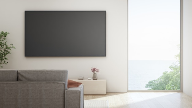 TV on white wall against sofa in home or villa.