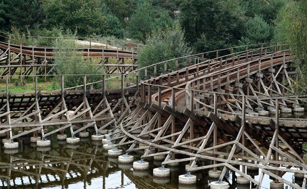 Twee achtbanen naast een meer in een themapark