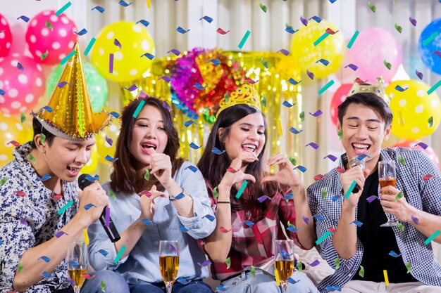 Twee gelukkige paren drinken champagne op een feestje.