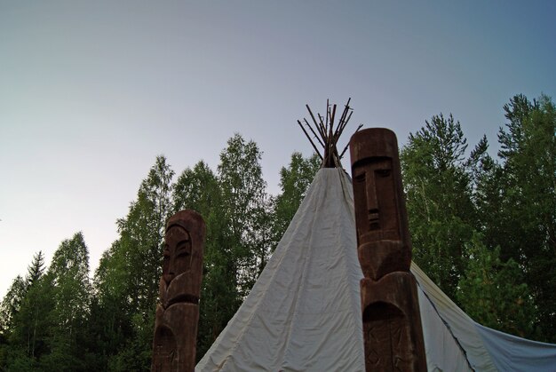 Twee heidense houten totems voor een traditionele tent