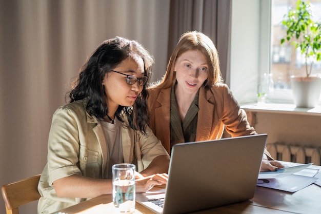 Twee jonge zakenvrouwen netwerken voor laptop