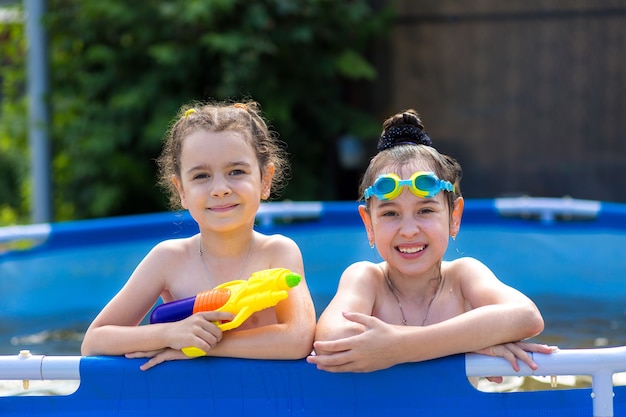 Foto twee kleine meisjes spelen in het zwembad