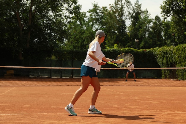 Twee mensen tennissen op gravel