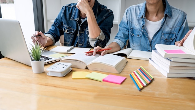 Twee middelbare schoolstudenten of klasgenoten met hulpvriend homeworks die in klaslokaal leren