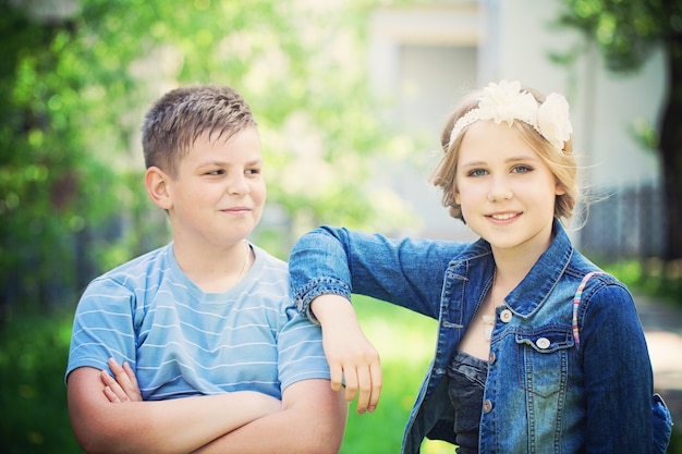 Foto twee mooie kinderen buiten jonge jongen kijkt naar meisje