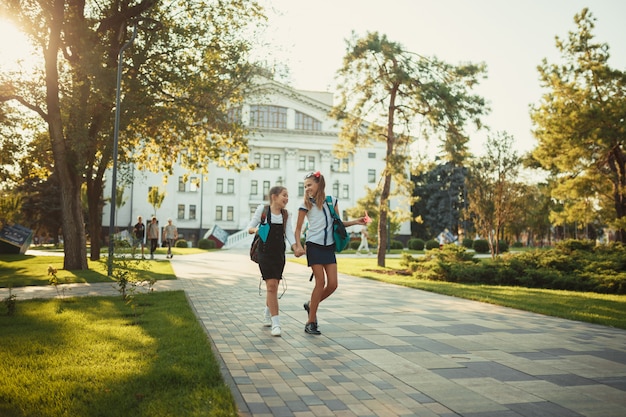 Twee schoolvrienden lopen na de lessen in een park bij de school
