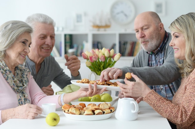 Twee senior koppels die thee drinken