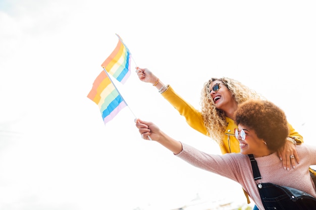 Twee vrouwelijke vrienden die rondhangen in de stad die LGBT golven