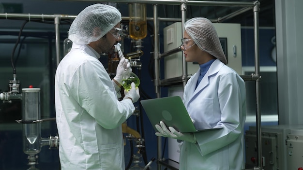 Twee wetenschappers in professioneel uniform werken in laboratorium