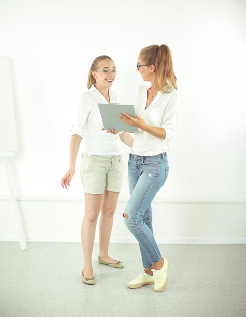 Twee zakenvrouwen die een informele bijeenkomst hebben in een modern kantoor