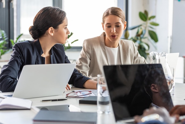 twee zakenvrouwen in formele kleding aan tafel in het kantoor