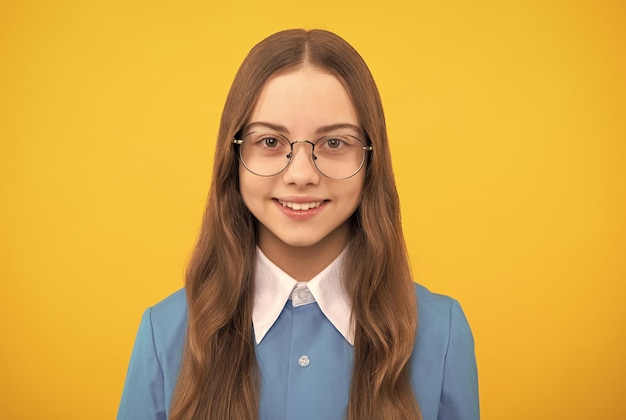 Tween girl Happy girl child in eyeglasses yellow background Girls education Back to school Knowledge day September 1 Happy girlhood and childhood