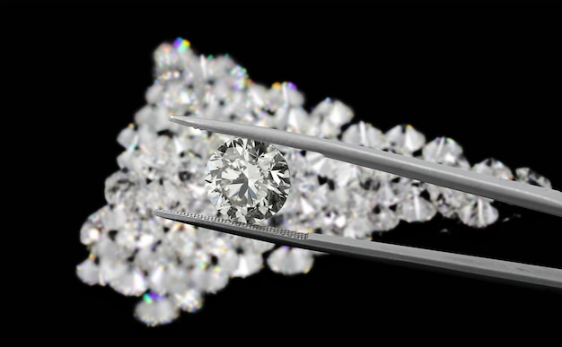 Tweezers hold Big Round Brilliant Cut Diamond on blur diamond and black background
