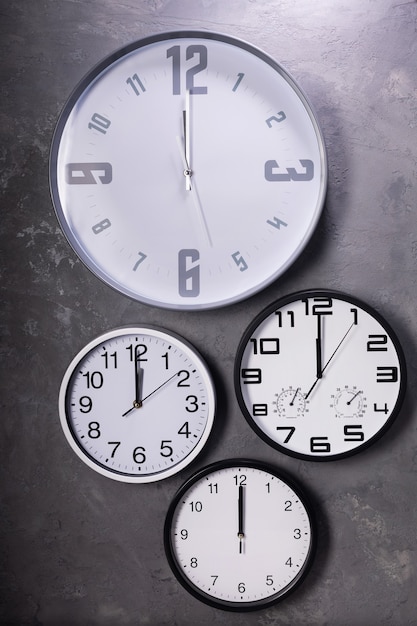 Twelve o'clock at wall clock with concrete background, grey texture surface