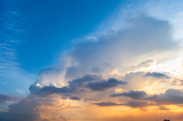 Twilight blue bright and orange yellow dramatic sunset sky in countryside or beach colorful cloudscape texture with white clouds air background