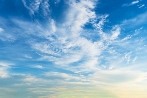 Twilight blue bright and orange yellow dramatic sunset sky in countryside or beach colorful cloudscape texture with white clouds air background