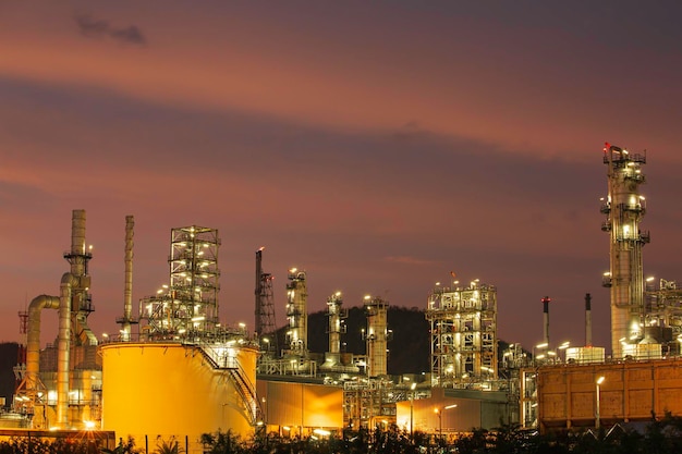 Twilight scene of tank oil refinery plant and tower column of\
petrochemistry industry in site construction