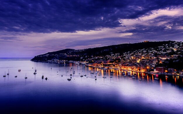 Twilight sunset over the Cote dAzur with purple highlights mirroring in the blue sea Villefranche France