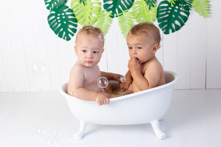 twin boys sitter twin brothers at the age of one year old