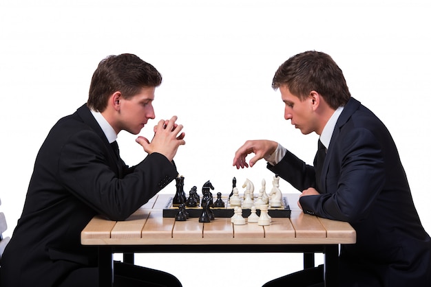 Twin brothers playing chess isolated on white