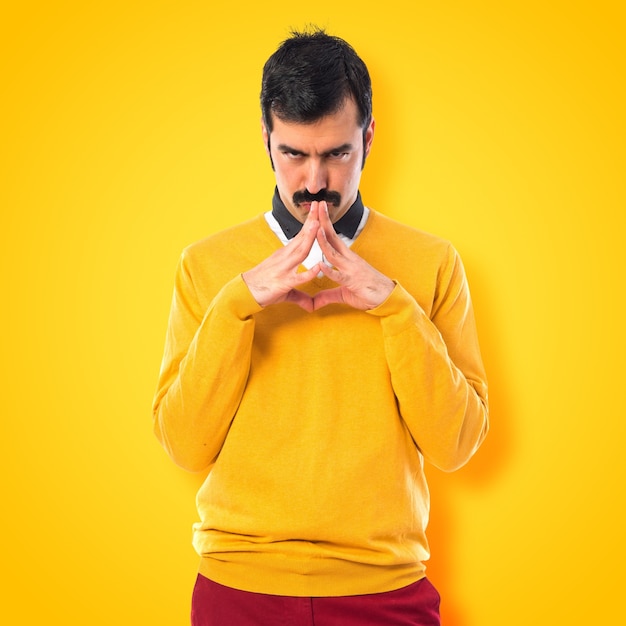 Twin brothers thinking on colorful background