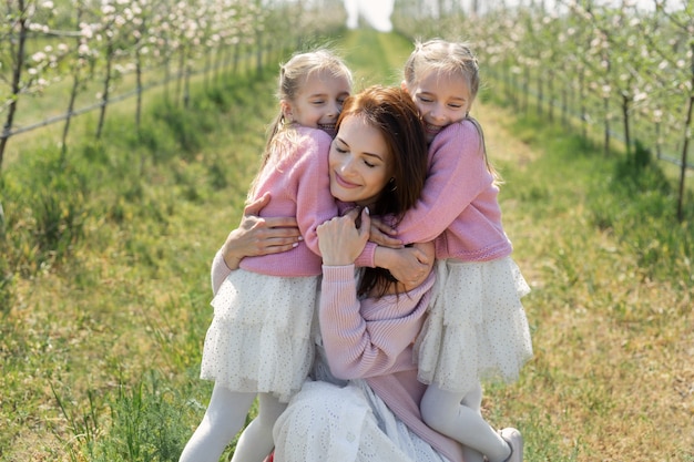 Twin sisters with their beautiful mother on the field