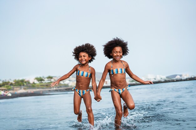 Twins having fun on the beach