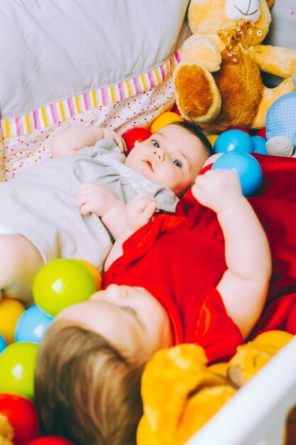 Twins lying in crib at home