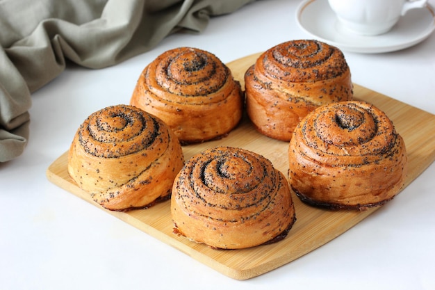 Twisted buns with poppy seeds homemade cakes on the table