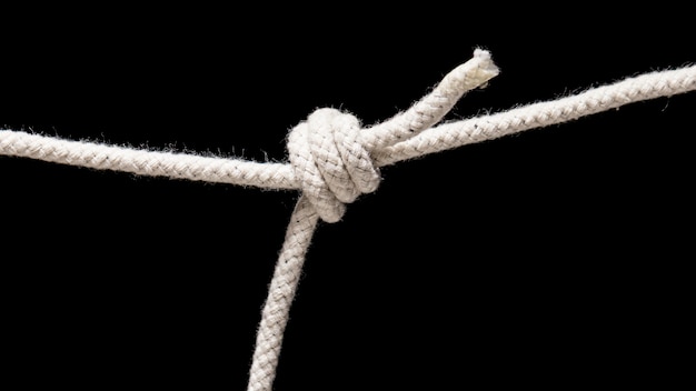 Photo twisted cotton rope isolated on black background