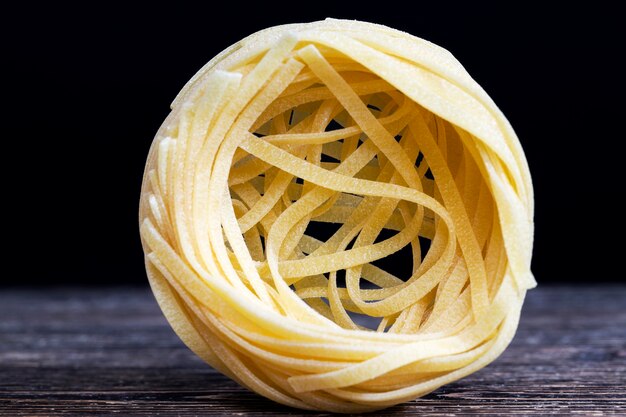 Twisted into the form of a slot, one serving of this noodle from wheat flour, closeup