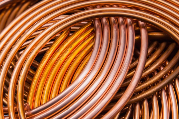 Twisted new copper tubes on a black background