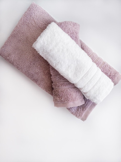 Twisted pink and white towels on the white background