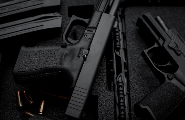 Two 9mm pistols hold slides on a wooden table